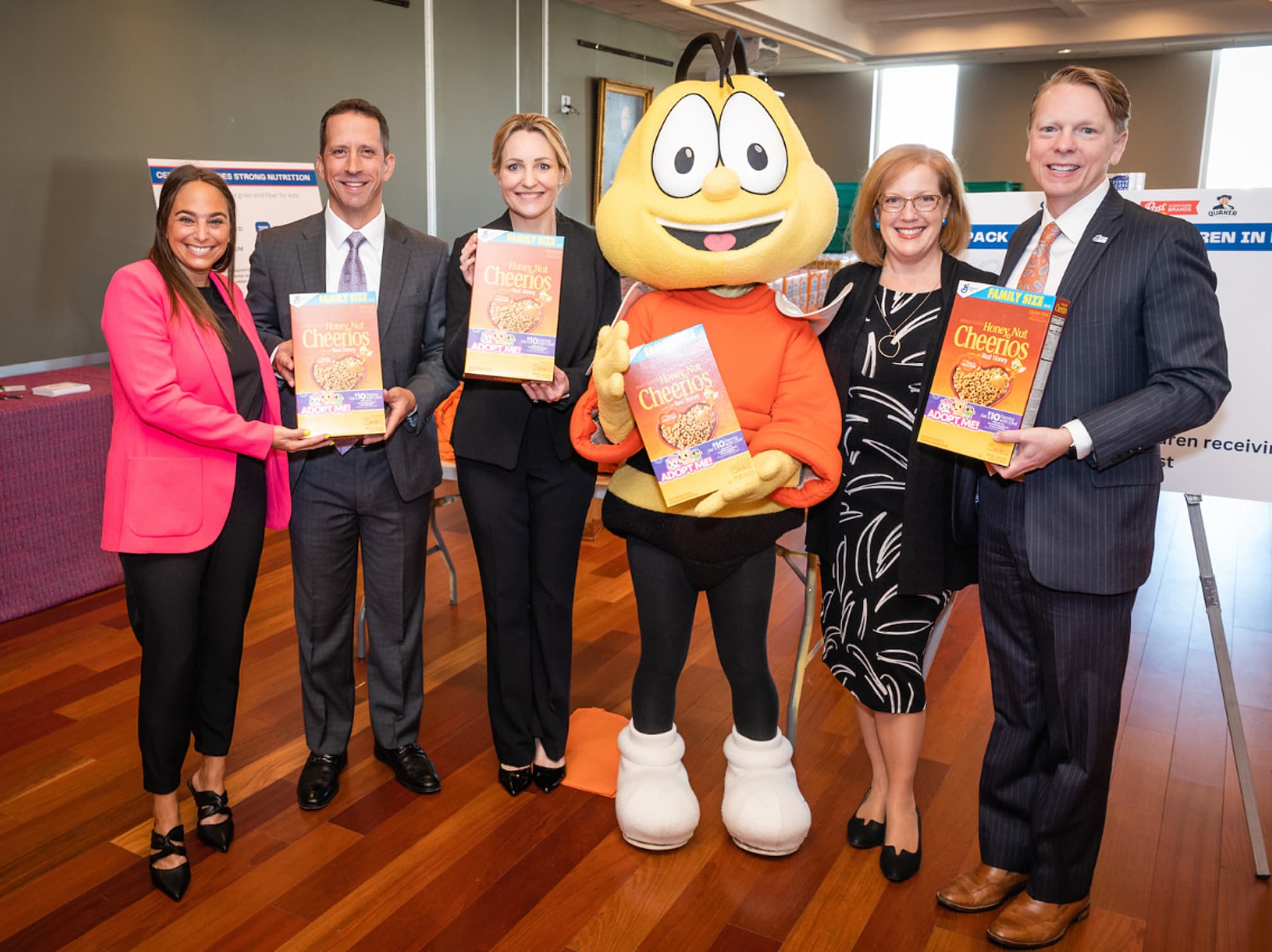 General Mills team holding boxes of Cheerios with BuzzBee